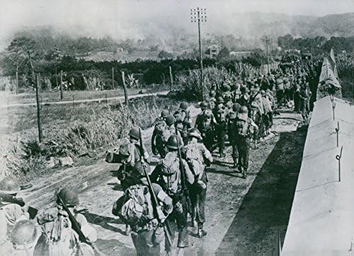 תצלום וינטג 'של בעלות הברית עוברים בדרום צרפת. חיילים אמריקאים מתקדמים בדרום צרפת, צועדים על פני קיר פלדה וקיר